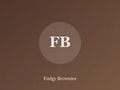 Stack of fudgy brownies with shiny crackly tops on parchment
