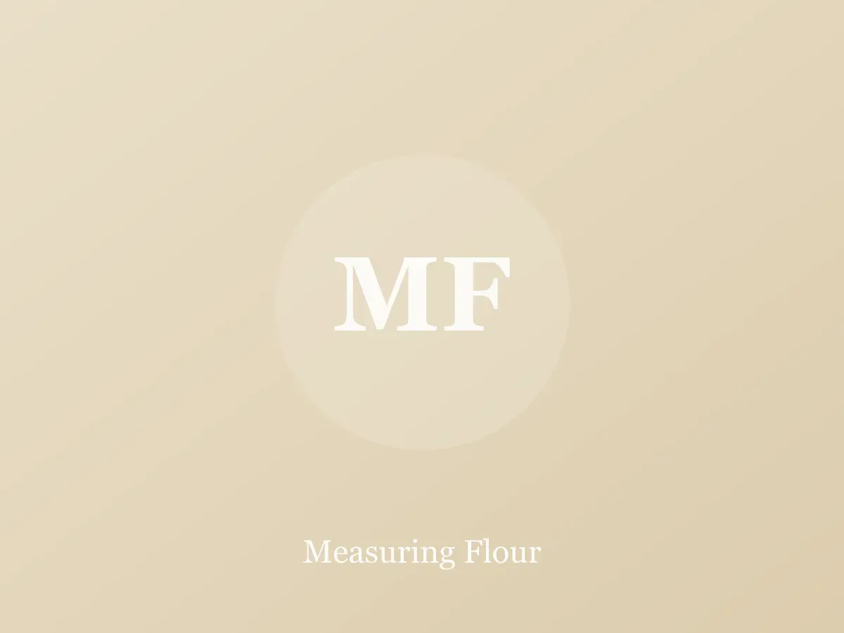 Flour being spooned into a measuring cup and leveled with a knife